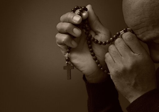 black man praying to god Caribbean man praying with people stock image stock photo