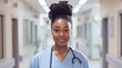 © Ivy - a beautiful black nurse standing in a hospital hallway