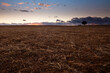 © ADDICTIVE STOCK - Tranquil field at dusk with dramatic clouds