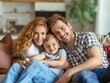 © Ace64 Studio - Happy family with child sitting on sofa, young parents embracing son relaxing on couch together