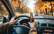 © burntime555 - Man irresponsibly driving while holding a beer bottle, depicting the danger of drink driving.
