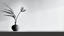  A Black And White Photo Of A Vase With A Flower In It And A Twig Sticking Out Of It.