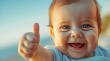 Image Of A Laughing Baby With Bright Eyes And A Charming Smile, Giving A Thumbs-up To The Camera