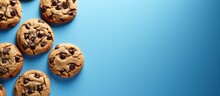 White Packaged Chocolate Chip Cookies On Blue Background With Top View And Empty Space.