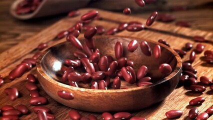 Poster - Bean grains fall into a wooden bowl. Filmed on a high-speed camera at 1000 fps. High quality FullHD footage