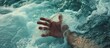 Drowning person's hand struggling in turbulent sea.