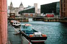 Liverpool, UK - October 10 2023 : Albert Dock, No Logos Or Recognizable People With Boats Docked In The Harbour And Famous Maritime Landmarks In The Background With Old And Modern Architecture