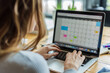 © mila103 - businesswoman using a laptop to manage schedules, with a calendar on the screen