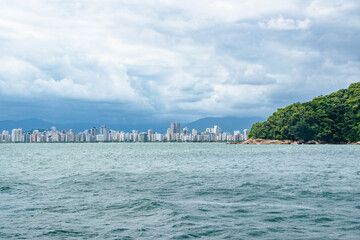 Wall Mural - Stretching City Skyline of Santos Sao Paolo Brazil on Cloudy Day With Forest Coastline