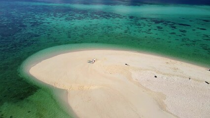 Wall Mural - a couple of men and women at a white sandbank in the ocean of Koh Lipe Island Southern Thailand