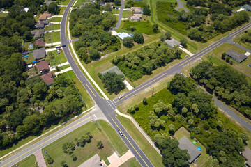 Wall Mural - Aerial view of american small town in Florida with private homes between green palm trees and suburban streets in quiet residential area