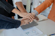 © kamiphotos - meeting team are putting hands together, Close up of a group of business people putting their hands together, Stack of hands, Unity and teamwork concept, success concept.