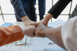 © kamiphotos - meeting team are putting hands together, Close up of a group of business people putting their hands together, Stack of hands, Unity and teamwork concept, success concept.