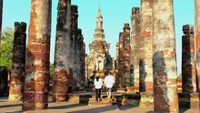 Sukhothai Old City, Thailand. Ancient City And Culture Of South Asia Thailand, Sukhothai Historical Park,Couple Of Men And Women Visit Wat Mahathat, Sukhothai's Old Historical City In Thailand.