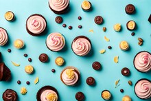 Flat Lay Composition With Cupcakes On Light Blue Background