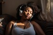 portrait of a relaxed woman black chubby listening to music 