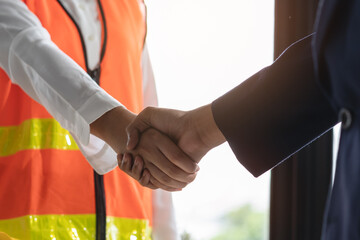 Wall Mural - construction worker and contractor. Client shaking hands with team builder in renovation site.