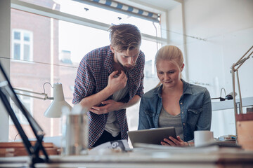 Two young people working in an office together