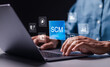 © Pakin - SCM, supply chain management concept, Businessman use laptop virtual SCM icon, Logistic and transport, organizing and controlling resources to meet the needs of customers.