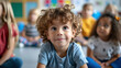 © SERHII - Young boy with curly hair smiling in a preschool classroom.
