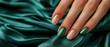 © Natalie - Woman's nails with beautiful green emerald manicure on green silk dress. AI generated