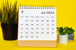 © Maurice Yom - July 2024 calendar with yellow over background. Monthly calendar concept