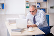 © Elnur - Old male employee working in the office