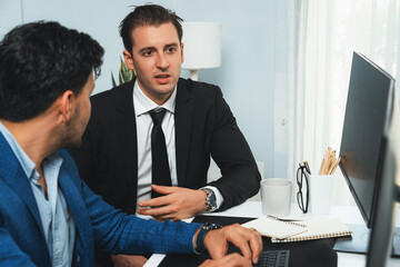 Two stock investors discussing and planning interesting market stock on monitor screen in real time. Analyzed trending database in growth of dynamic economic investment at modern workplace. Sellable.