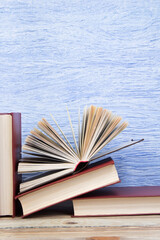 Wall Mural - open book, books on the blue background. Back to school. Education. Copy space for text.