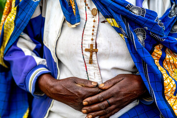 Wall Mural - Woman wearing a cross standing in a village in northern Rwanda