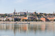 Panoramic view of the other bank of the Danube. Cranes among buildings. Danube River in the Big City.