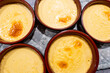 Stockholm, Sweden Bowls of Crème Brûlée desserts on the counter with vanilla.