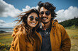 © gographic - Handsome man and beautiful woman in yellow raincoat and sunglasses smiling and looking at camera while standing in field