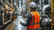 Industrial engineer with clipboard controlling factory facility