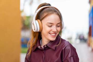 Sticker - Young pretty girl at outdoors listening music