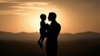 © Lednev - Silhouette of a father holding a child in his arms.