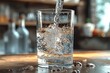 A clear stream of liquid cascades from a glass container, its soft splash reflecting the refreshing drinkware that sits on an indoor bar
