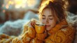 Young woman drinking tea in an autumn morning. Pretty woman with sweater at home enjoying hot coffee under blanket with closed eyes. Pretty woman drinking hot coffee at home with closed eyes.