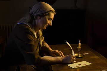 Poster - Lady in medieval costume writing a letter with a feather quill