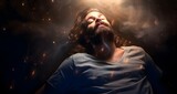 Fototapeta  - Blissful state of transcendental  Meditation -  handsome bearded young male with eyes closed lying supine surrounded by wispy ethereal smoke appearing to be asleep or meditating with a calm expression