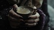 A person's hands with glossy dark nail polish cradling a hot, steamy beverage in a delicately patterned cup, evoking a sense of winter warmth.