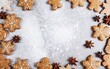 Christmas gingerbread cookies lie on the table together with cinnamon and pine cones
