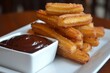 Churros con Chocolate: Crispy fried dough sticks served with rich, velvety chocolate sauce, a beloved Spanish dessert