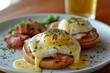 Classic eggs Benedict with velvety hollandaise sauce, atop English muffins, a gourmet delight.