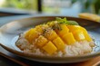 Mango Sticky Rice: Sweet glutinous rice paired with ripe mango slices and drizzled with coconut cream.