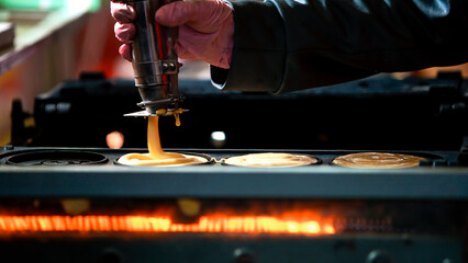 A vendor cooking dorayaki at roadside stands in Asia, Japanese form of a pancake