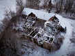 old collapsed and abandoned building in a lonely and snow covered landscape