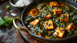Emanating culinary authenticity, a bowl of homemade saag paneer, a North Indian dish featuring spinach and cottage cheese, is placed on the table. Generative AI