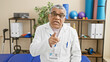 © Krakenimages.com - Middle-aged man in lab coat points at camera in a therapy clinic interior