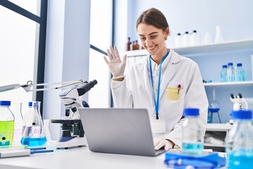 Wall Mural - Young caucasian woman scientist having video call at laboratory